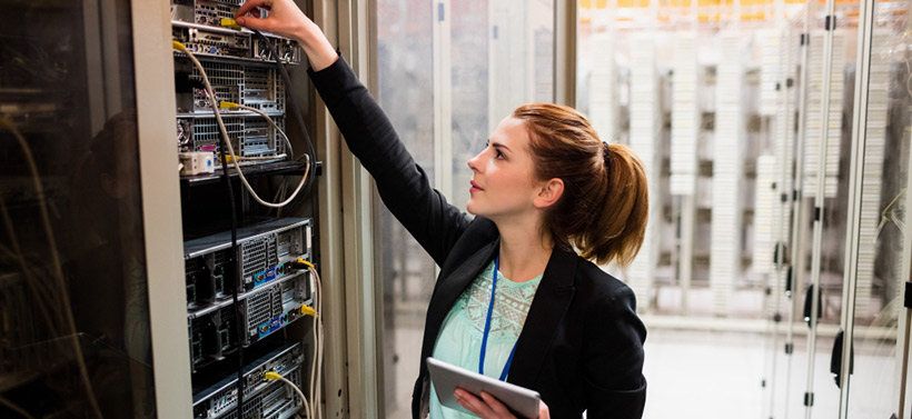 female technician preventing network failure in data center