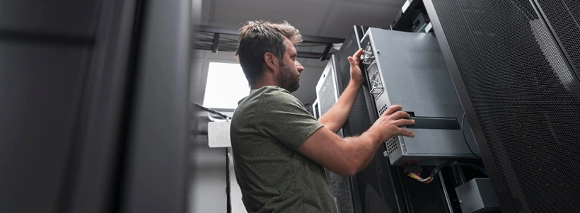 IT engineer working on availability uptime and downtime in server room