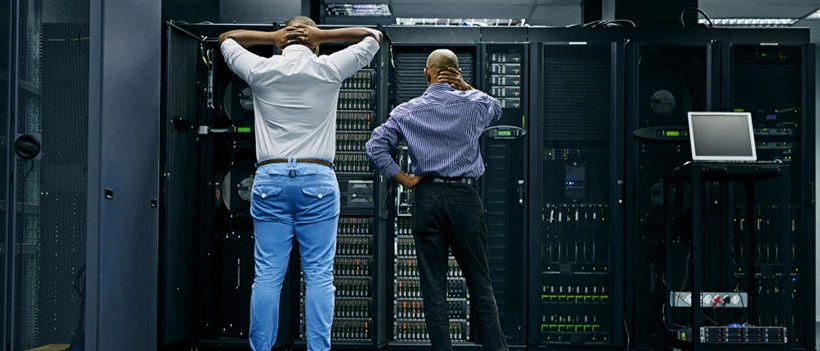 IT technicians building data center redundancy in server room