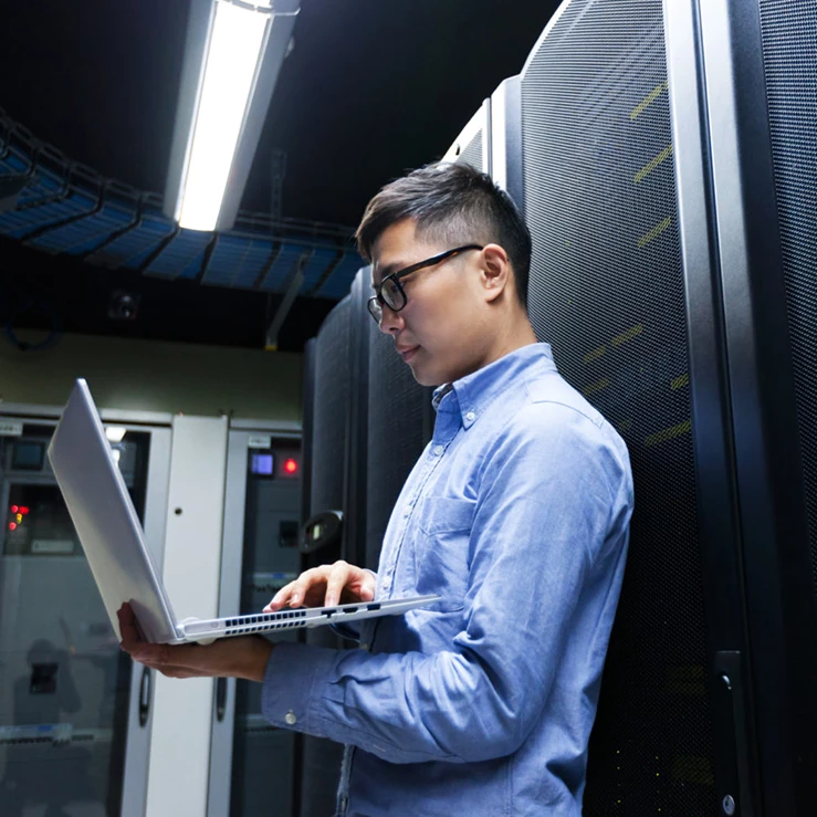asian male providing server management solutions in data center