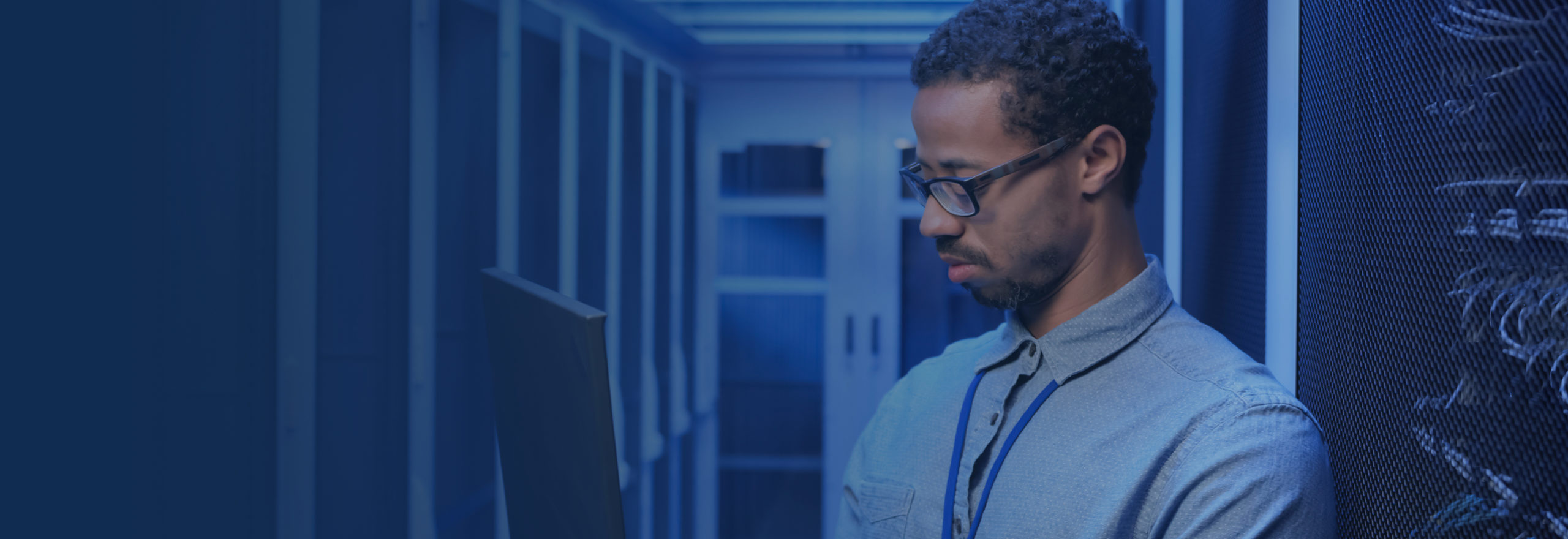 man on laptop in data center providing HPE alletra support